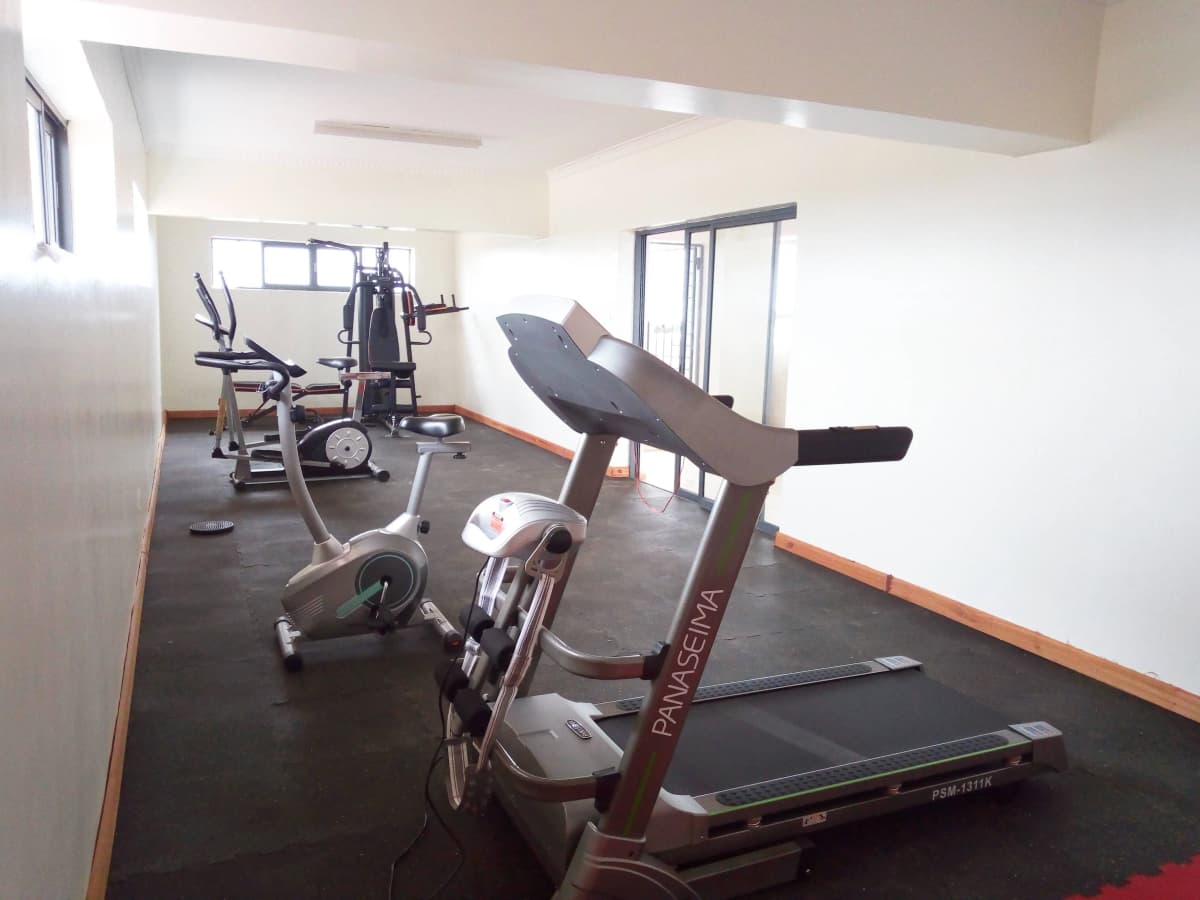 Modern gym with treadmills, stationary bike, and exercise equipment