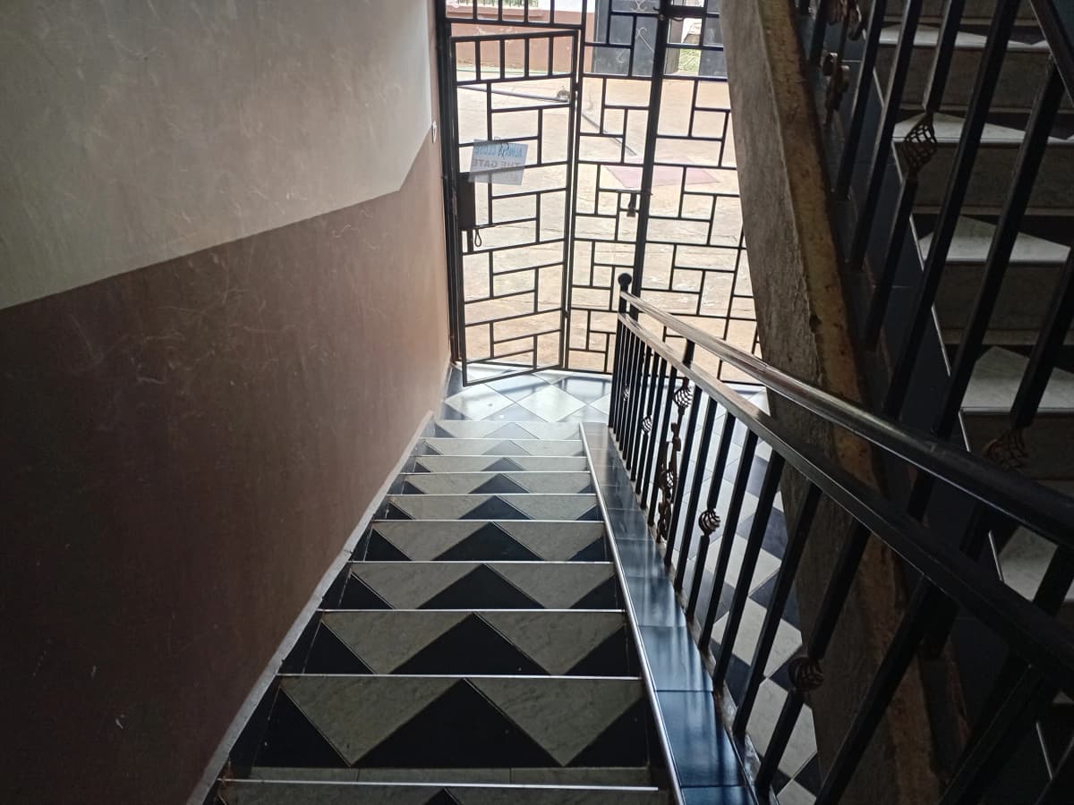 Building stairwell with geometric floor pattern and metal railings