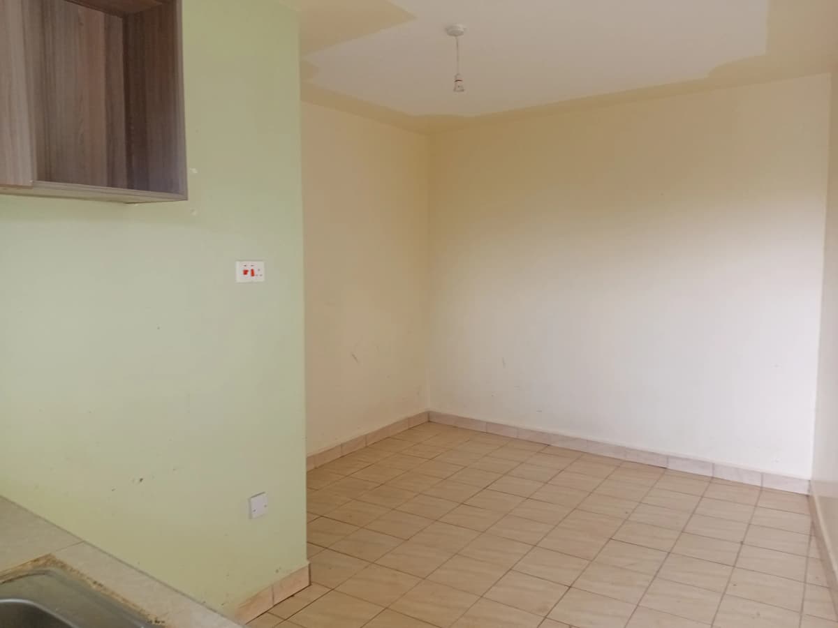 Empty room with tiled flooring and pale yellow walls