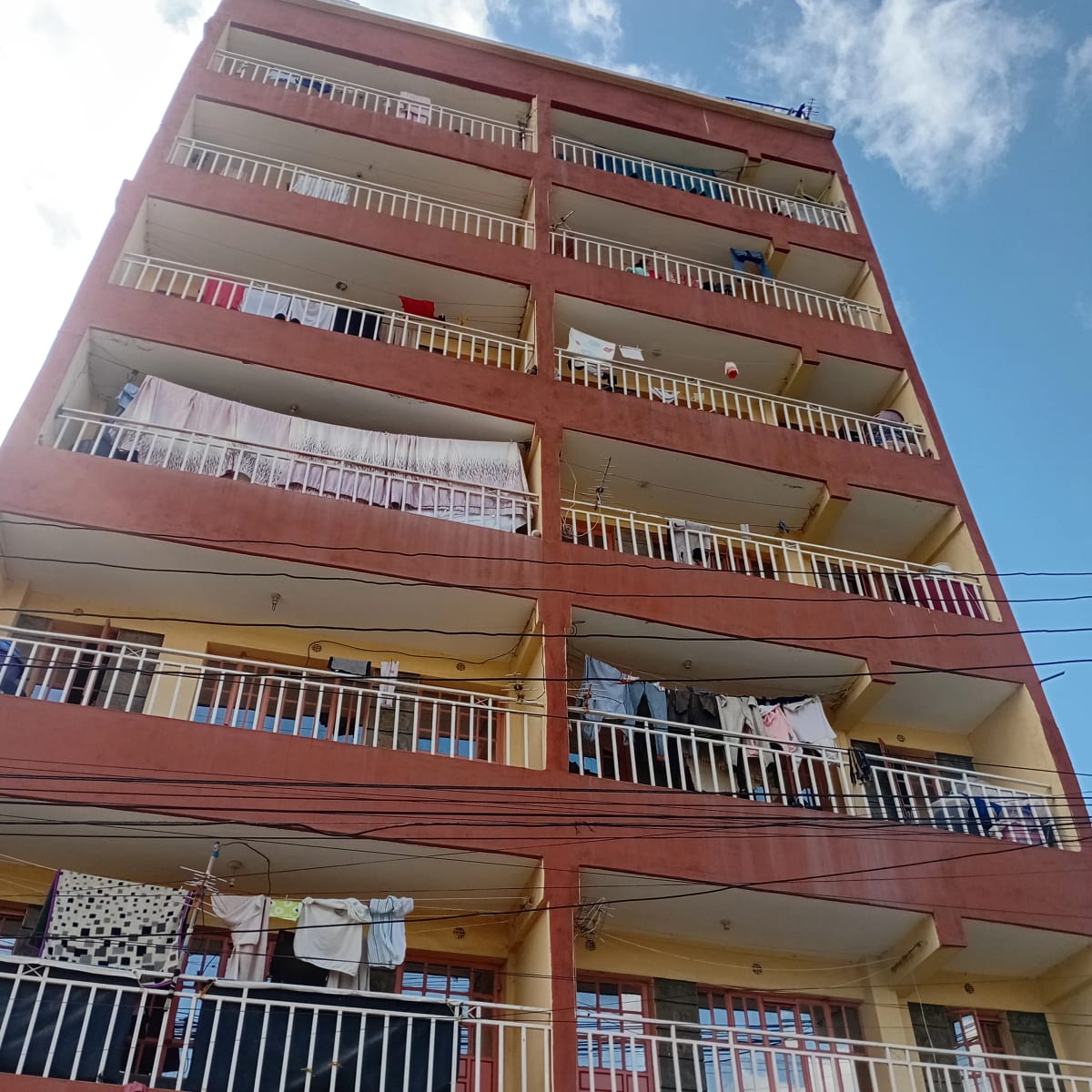 Multi-story residential building facade with balconies and railings