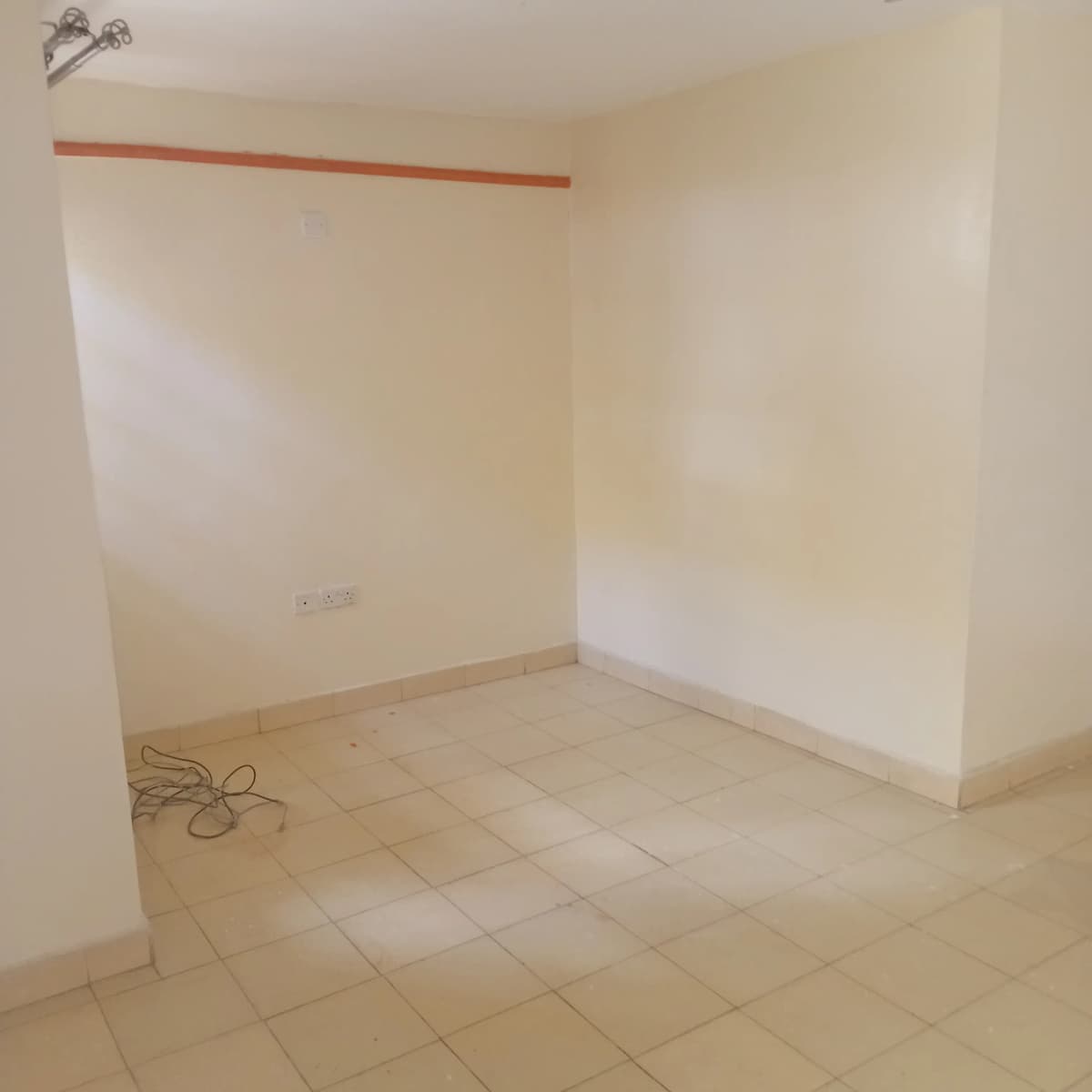 Empty room with tiled floor, under construction or renovation