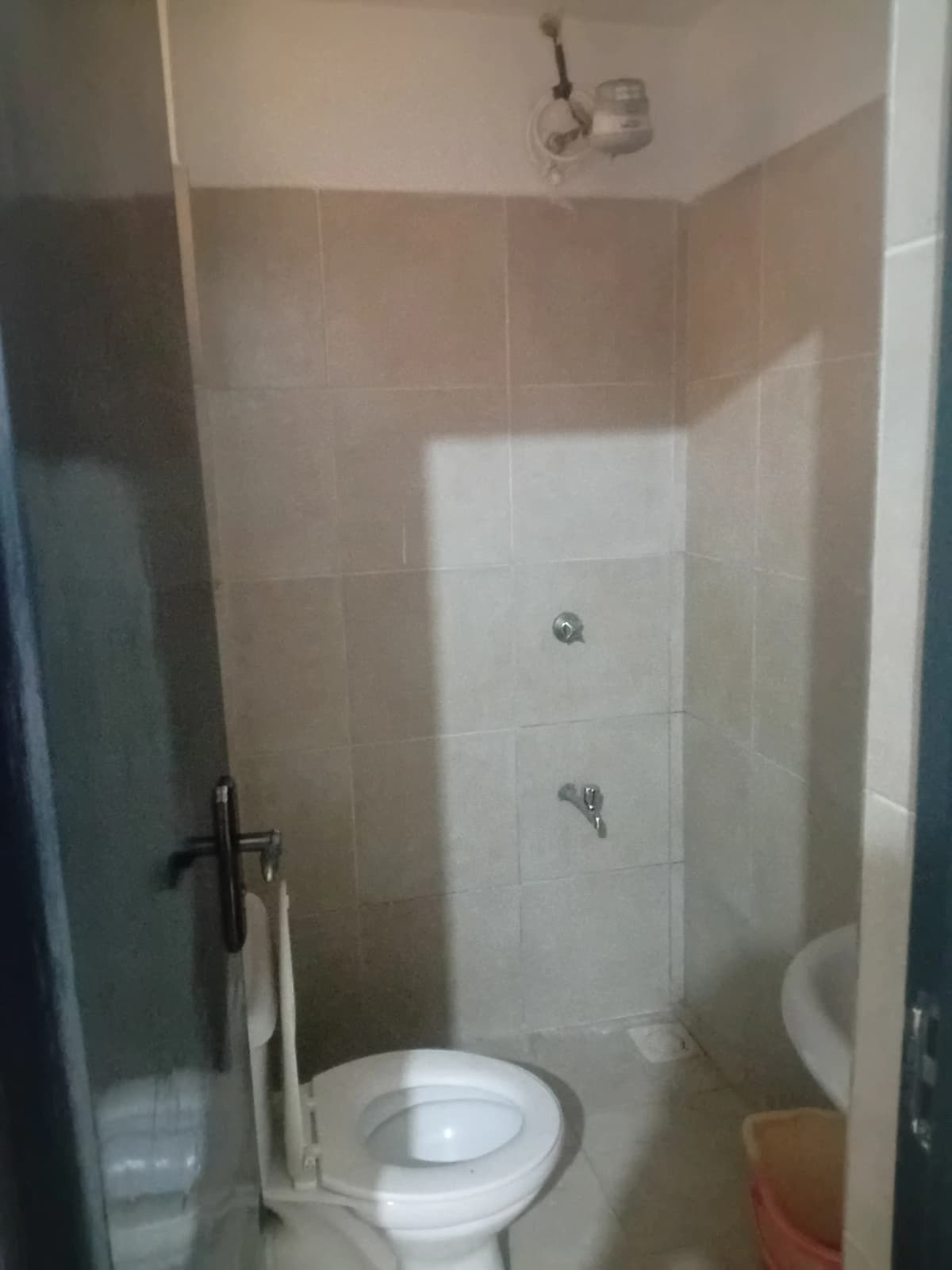 Compact bathroom with toilet and shower cubicle