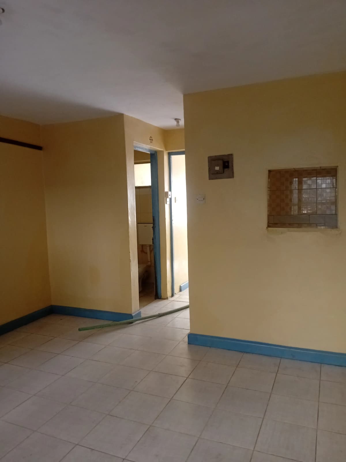 Bright corridor with yellow walls and blue trim