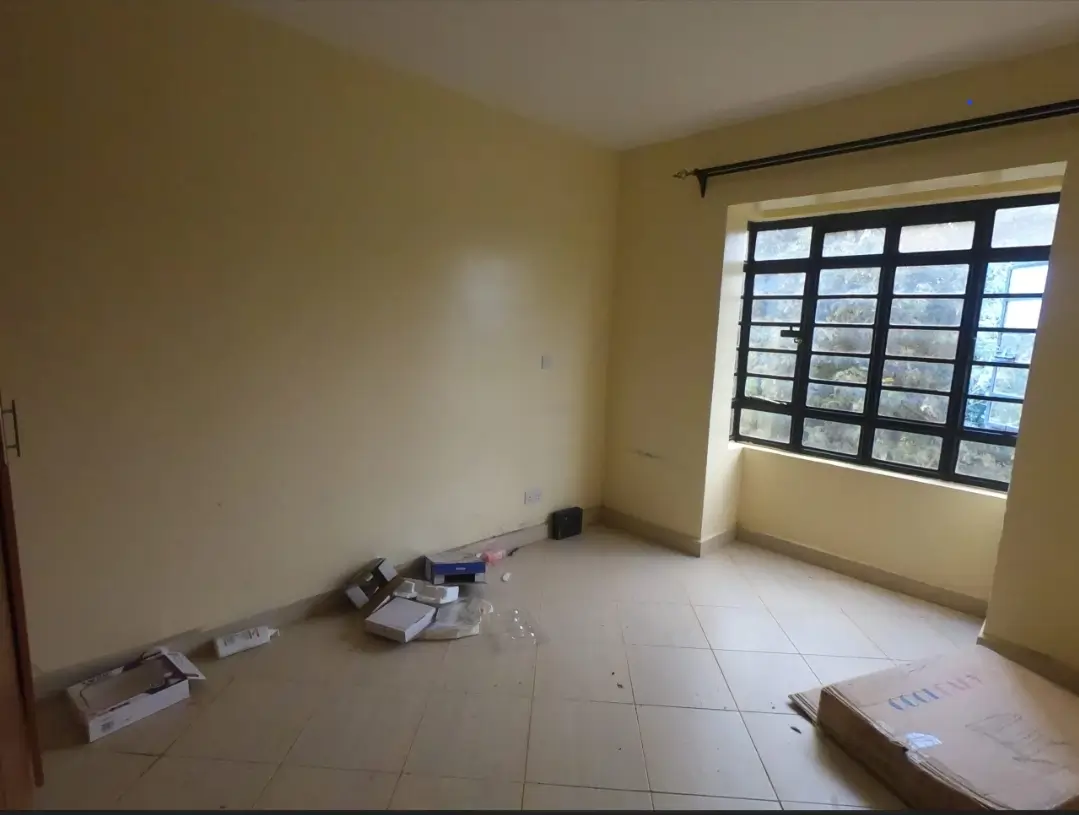 Unfurnished bedroom with large window and tiled flooring