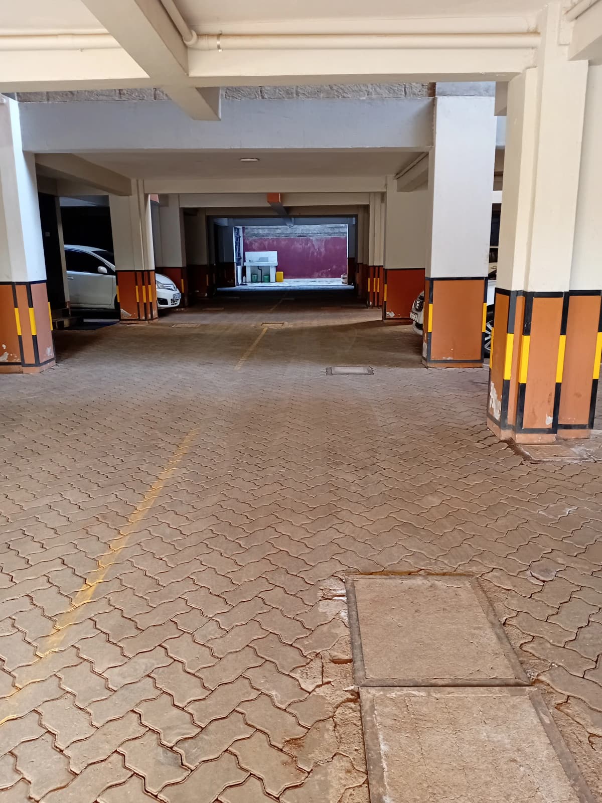 Underground parking garage with paved floor and barriers