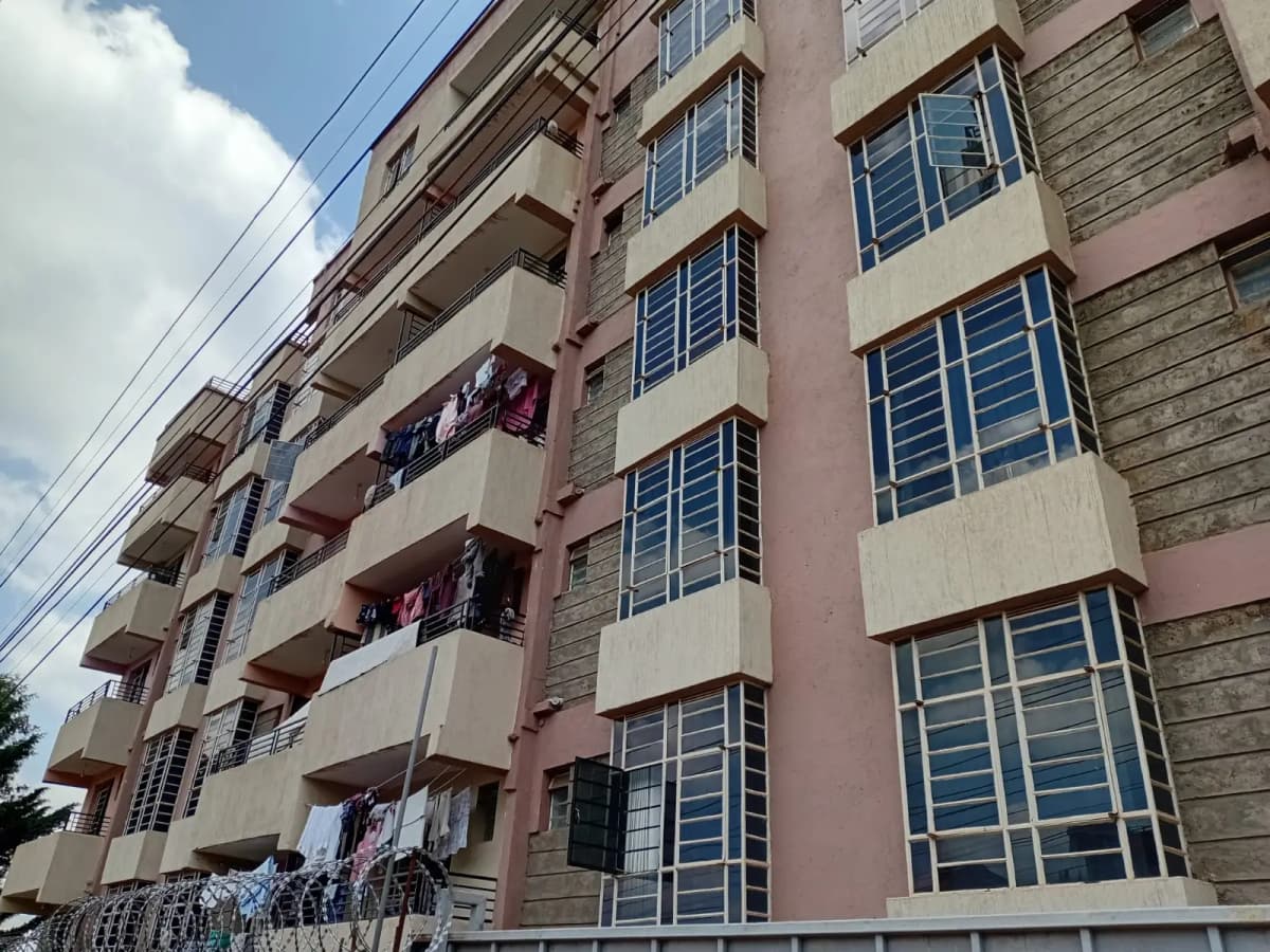 Multi-story residential building facade with balconies and laundry