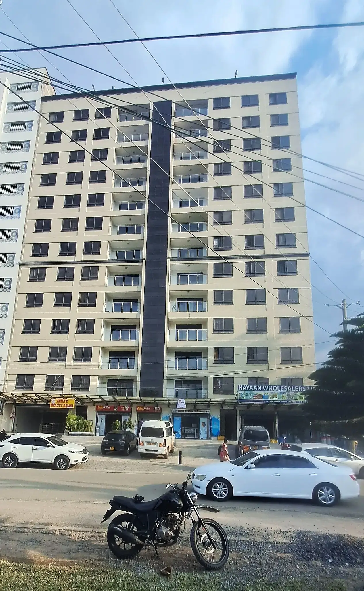 Multi-story residential building facade with ground-level parking