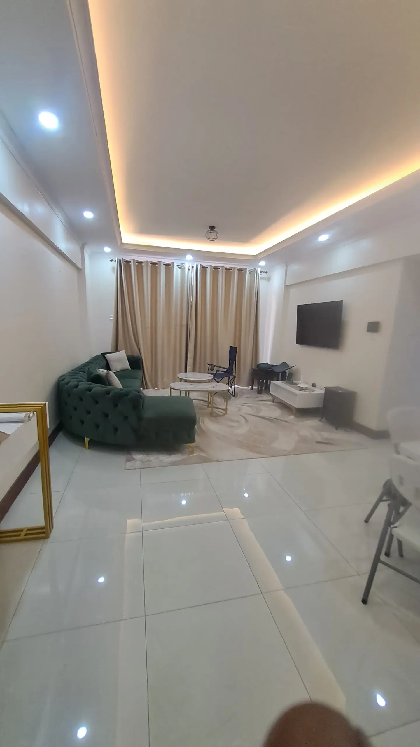 Modern living room with indirect ceiling lighting and curtains