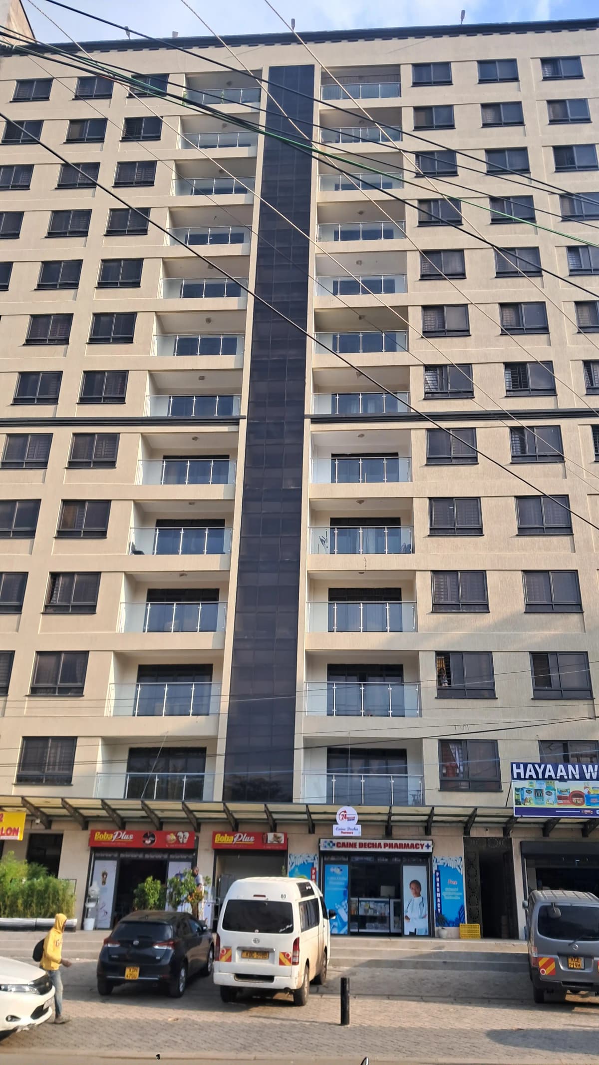 Multi-story residential building facade with ground floor retail