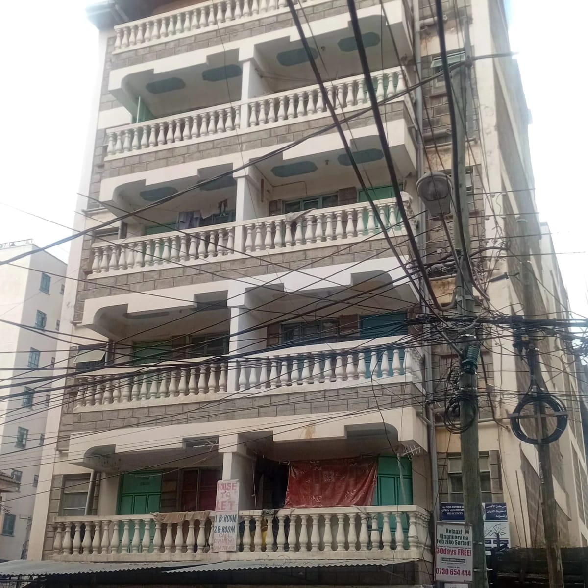 Multi-story residential building facade with ornamental balconies