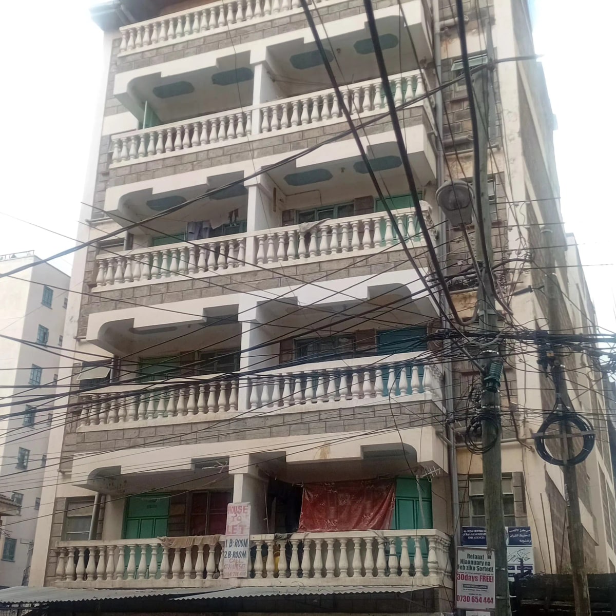 Multi-story residential building facade with ornamental balconies
