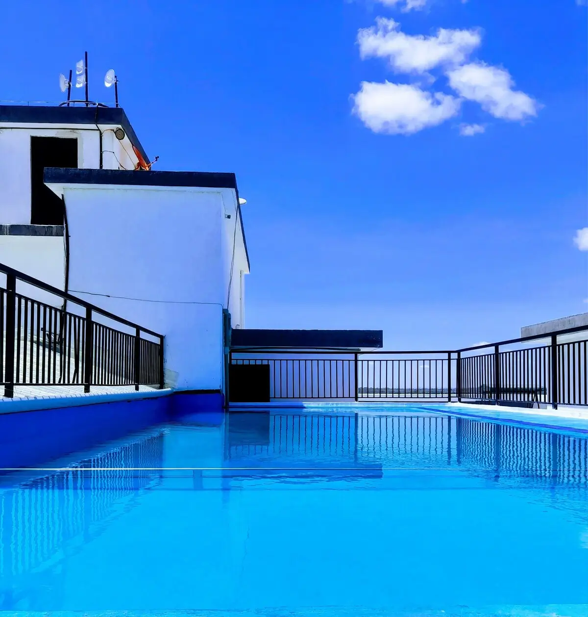 Rooftop swimming pool with city views and modern railings
