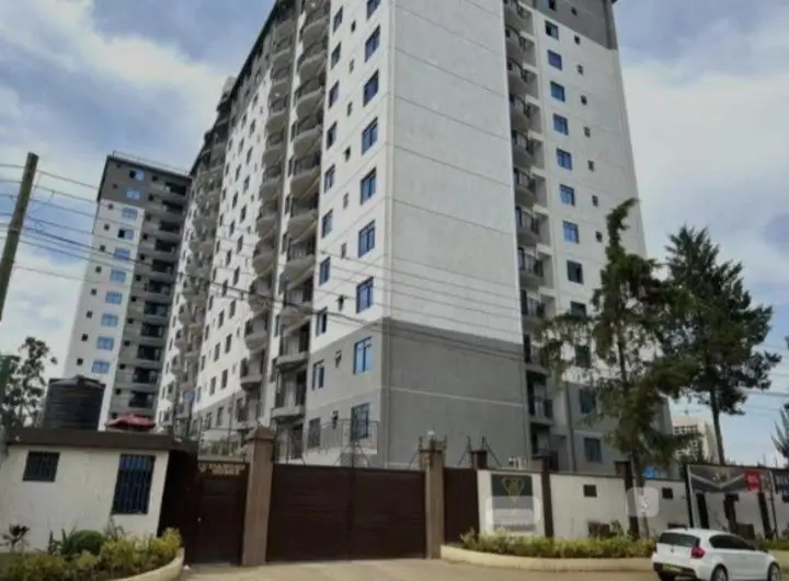 Multi-story residential building with gated compound entrance