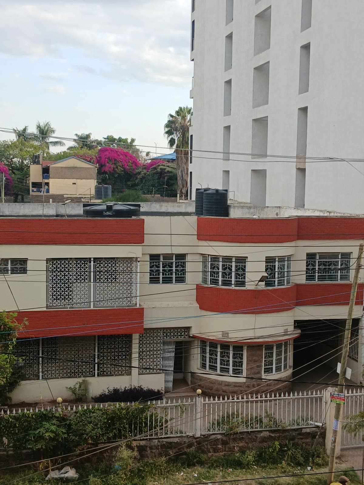 Multi-story residential building with red and white facade