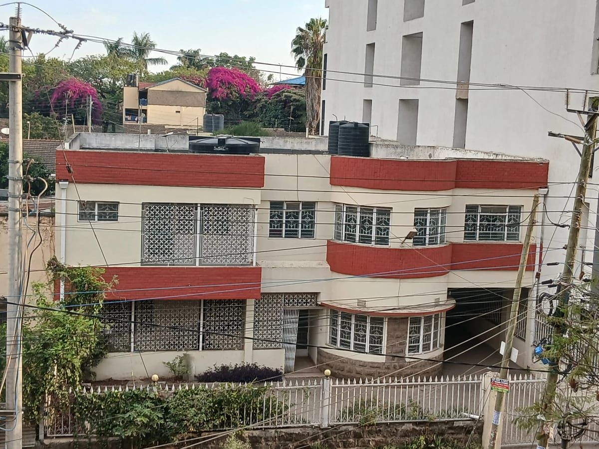 Multi-story residential building with red and cream facade