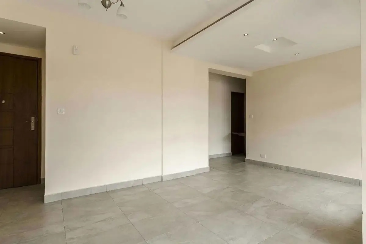 Empty living room with polished concrete flooring and neutral walls