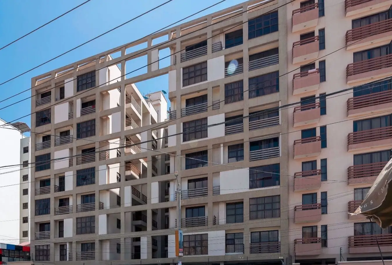 Multi-story residential building facade with mixed finishes