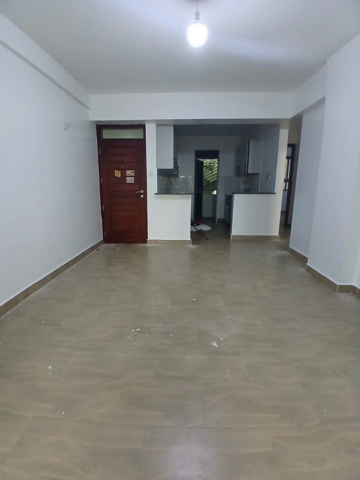 Empty living room with polished concrete floors and neutral walls