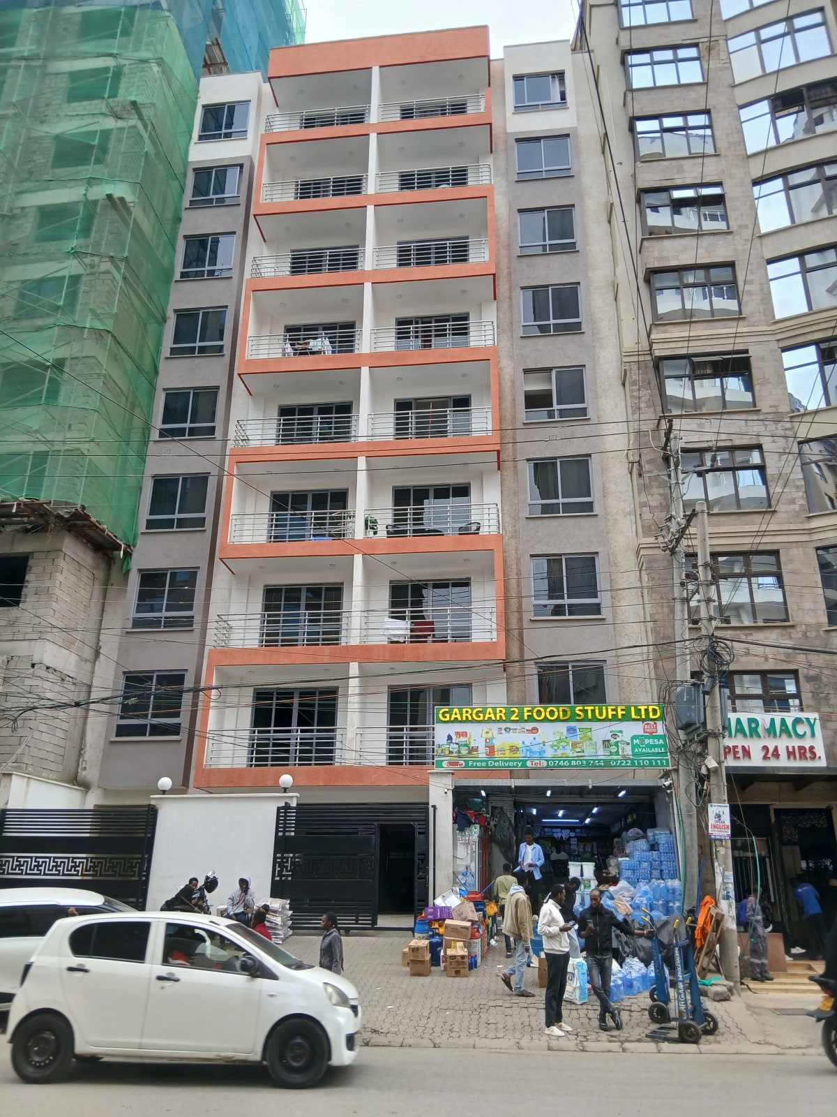 Multi-story residential building facade with ground floor retail