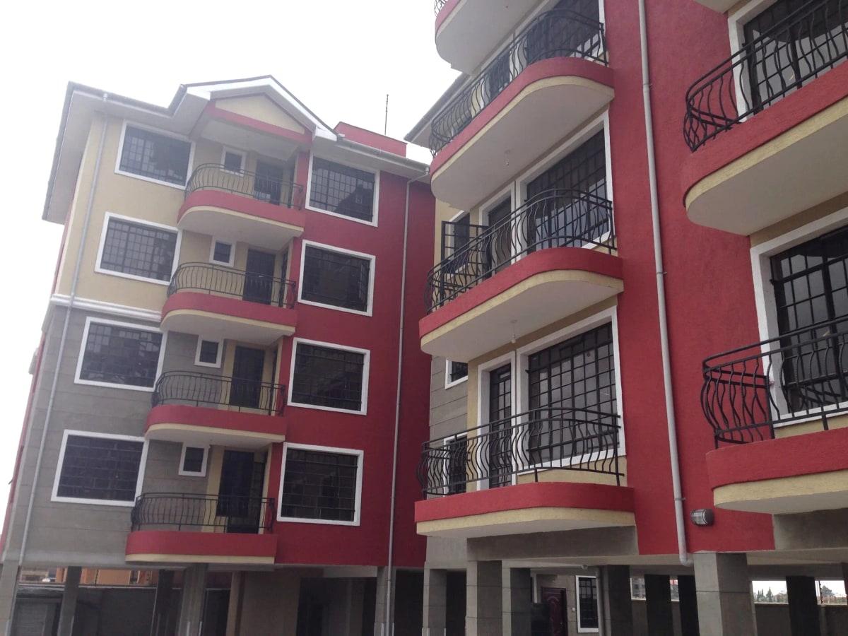 Multi-story residential building with red and cream facade