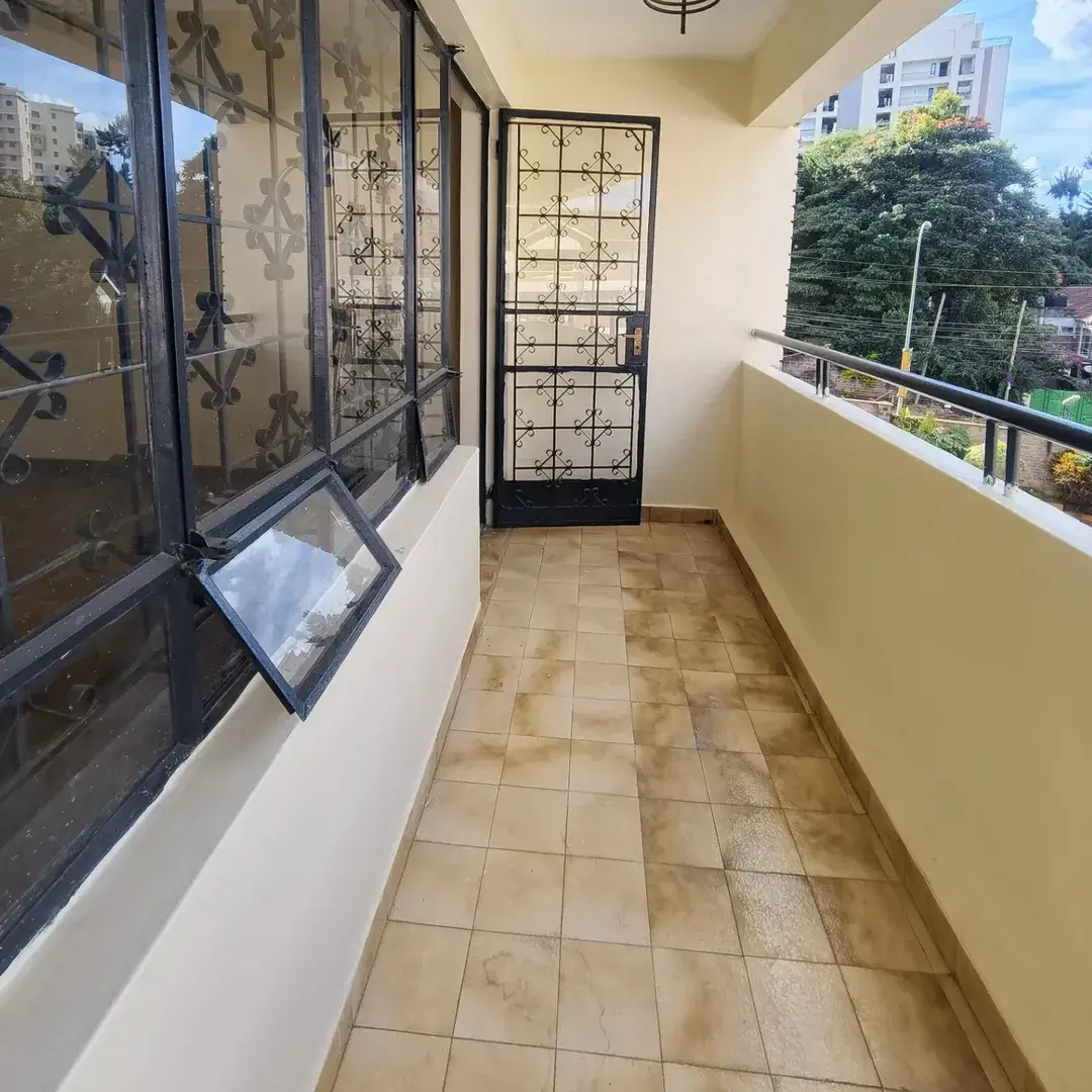 Covered balcony with terracotta tiles and city views