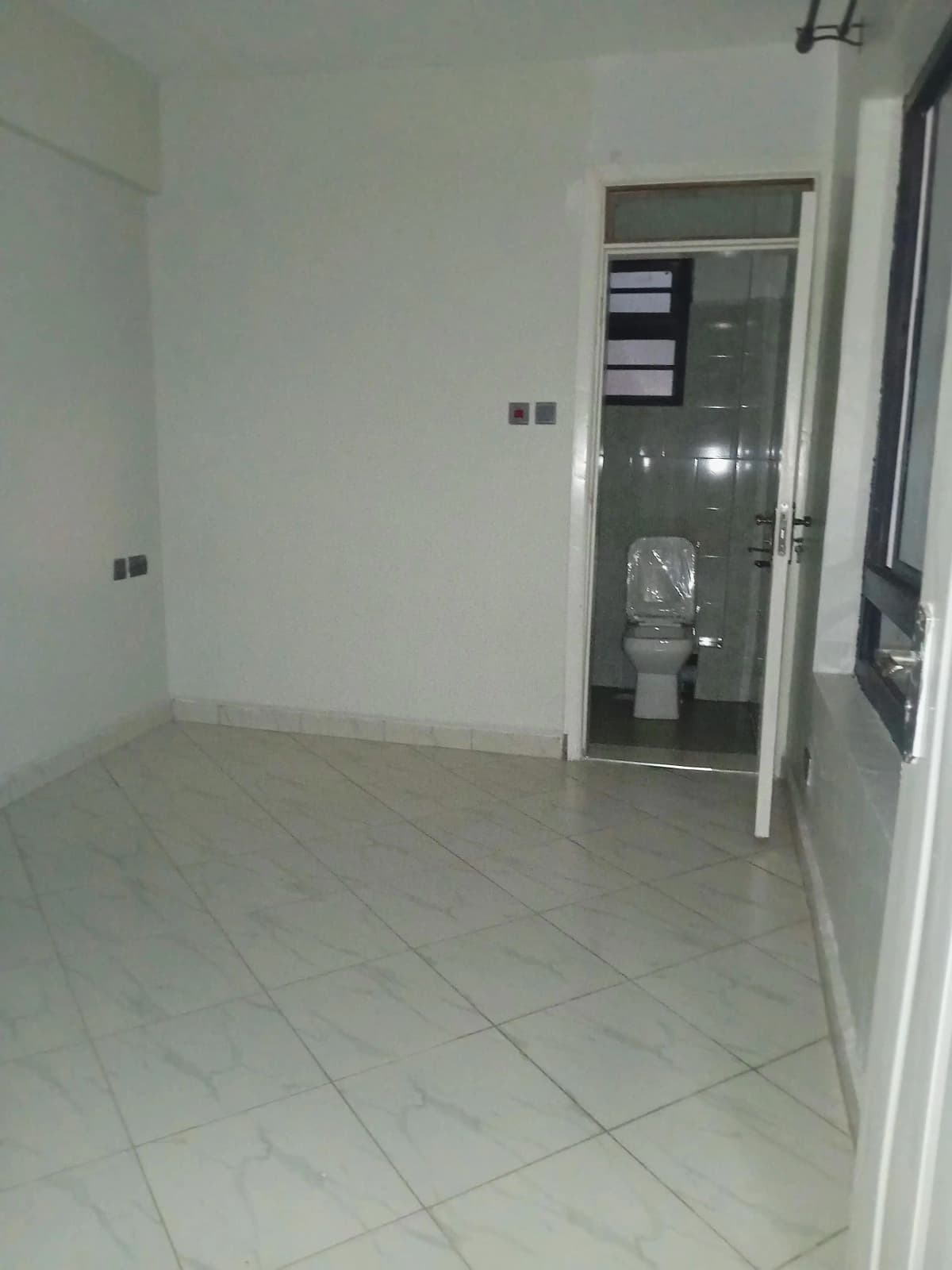 Minimalist corridor with tiled flooring and storage closet