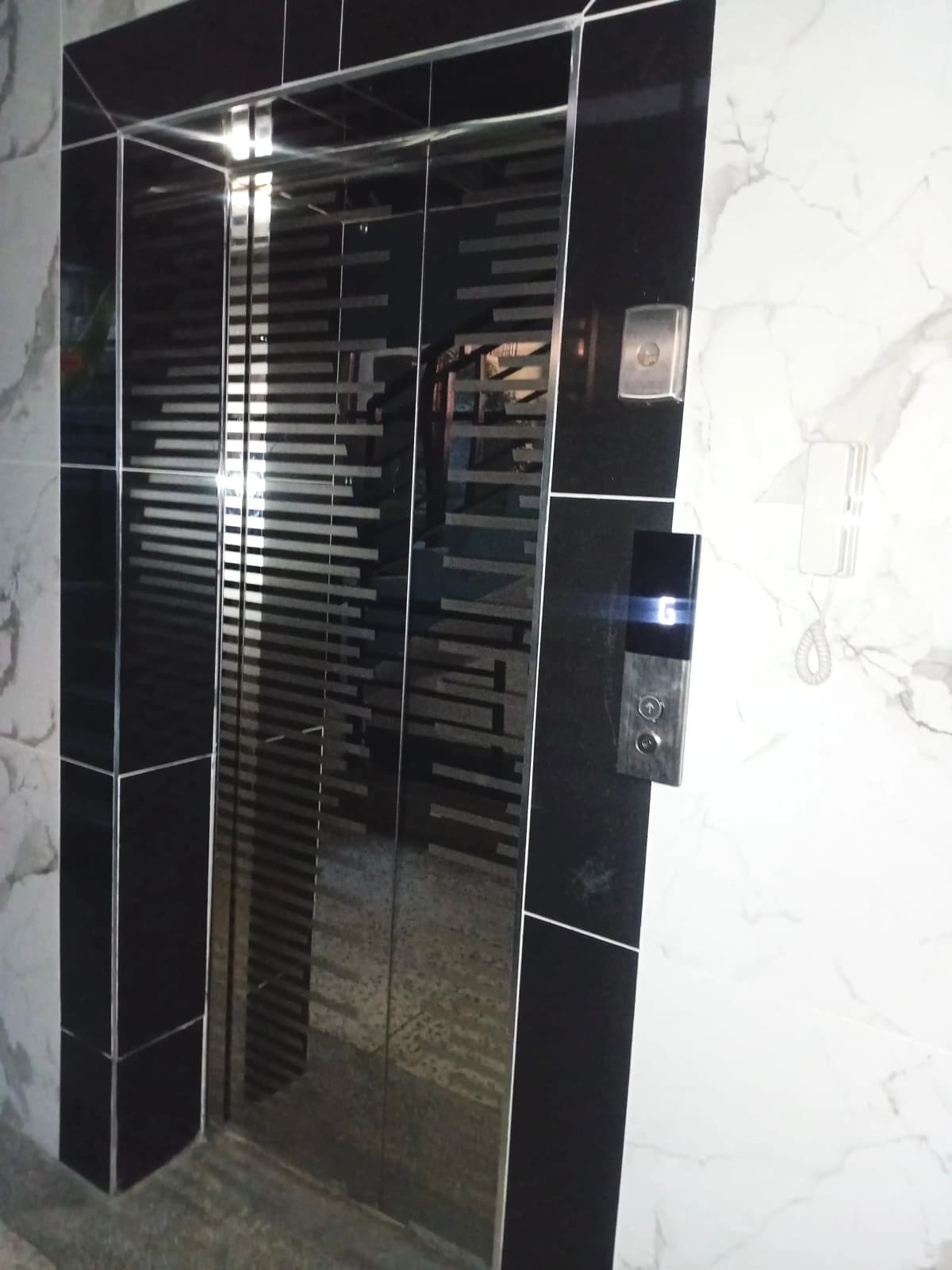 Modern black tiled shower enclosure with glass doors