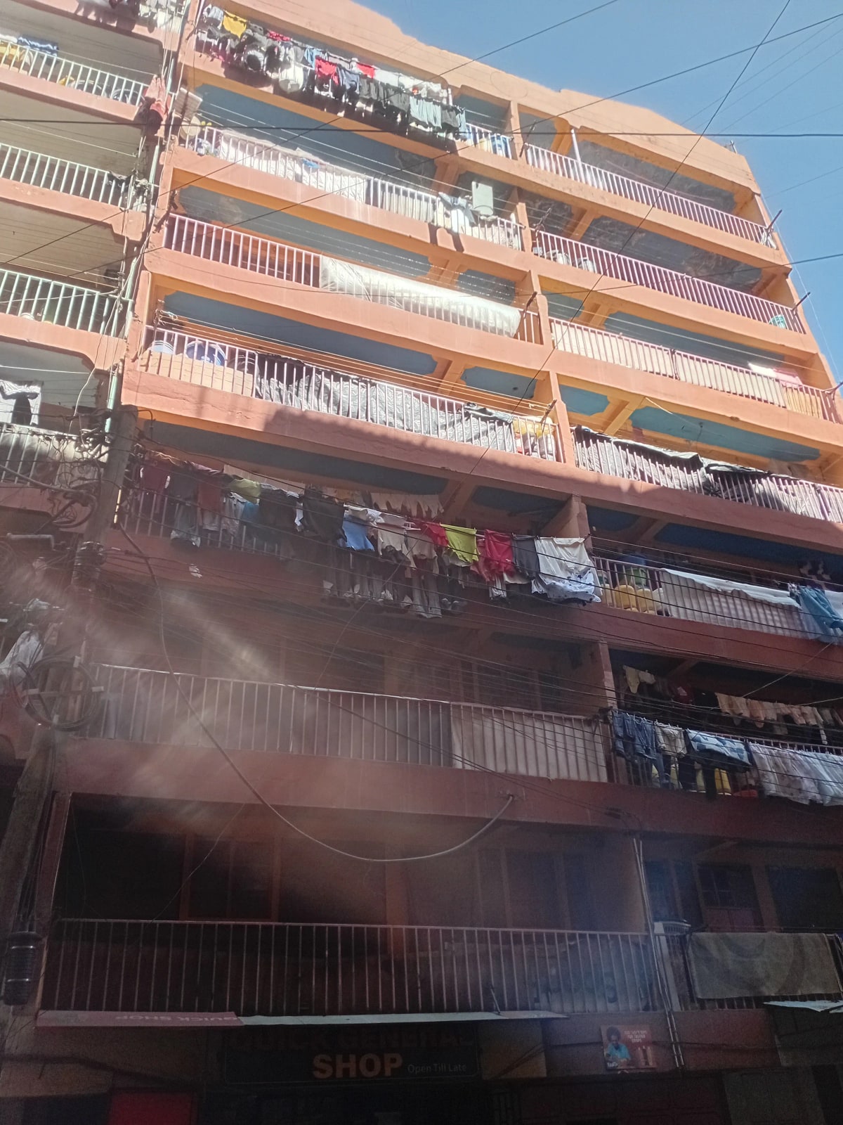 Multi-story residential building facade with balconies and clotheslines