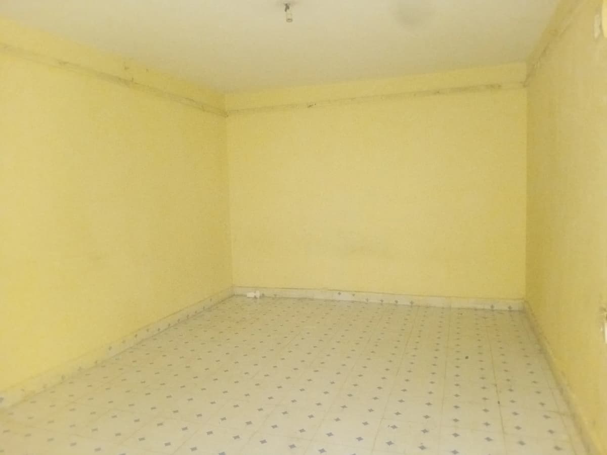 Empty room with yellow walls and dotted flooring