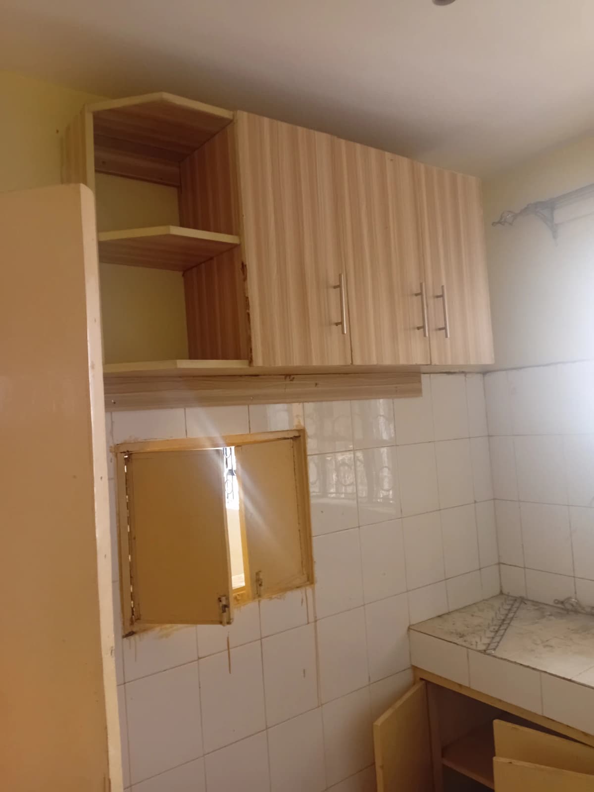 Kitchen with wooden cabinets and white tile backsplash