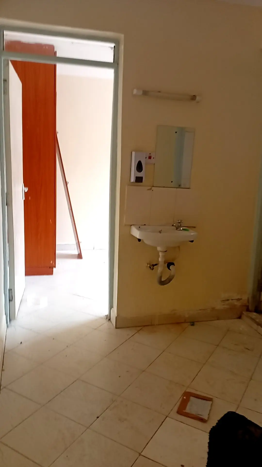 Bathroom with wall-mounted sink and open door