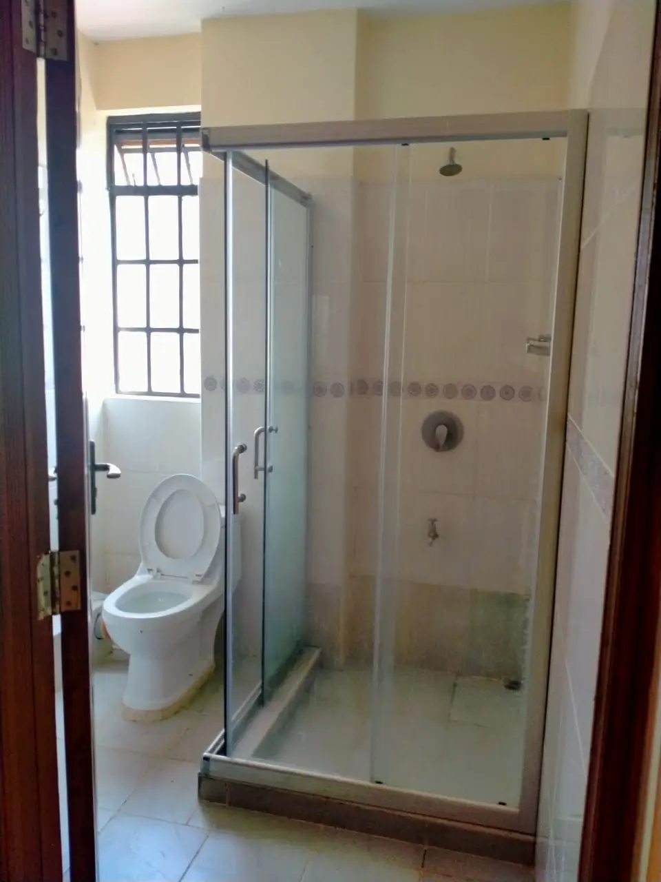 Modern bathroom with glass-enclosed shower and toilet