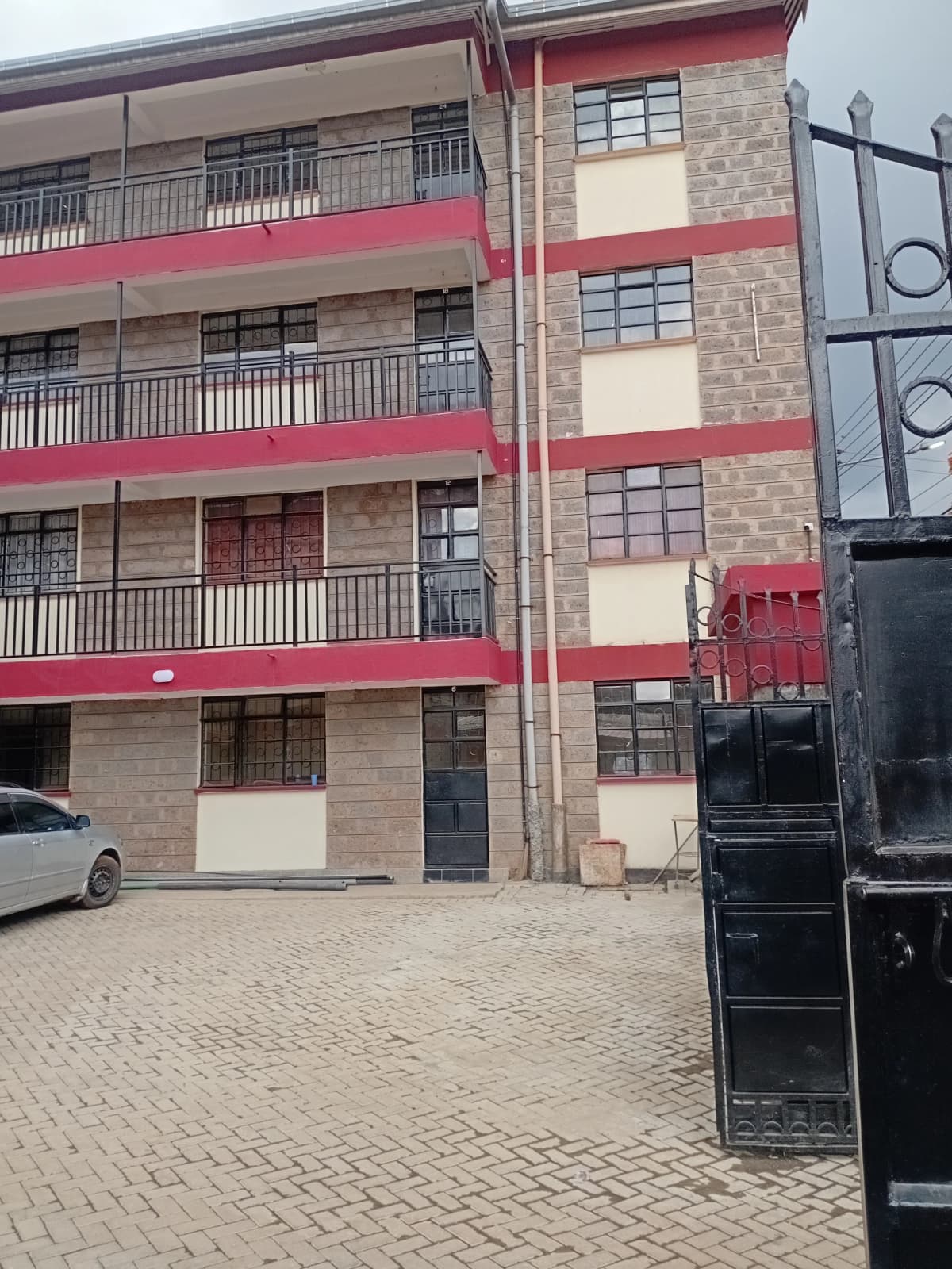 Multi-story residential building with red and cream facade